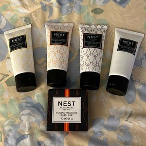 Nest travel toiletries. Shampoo, conditioner, body wash, and body cream.